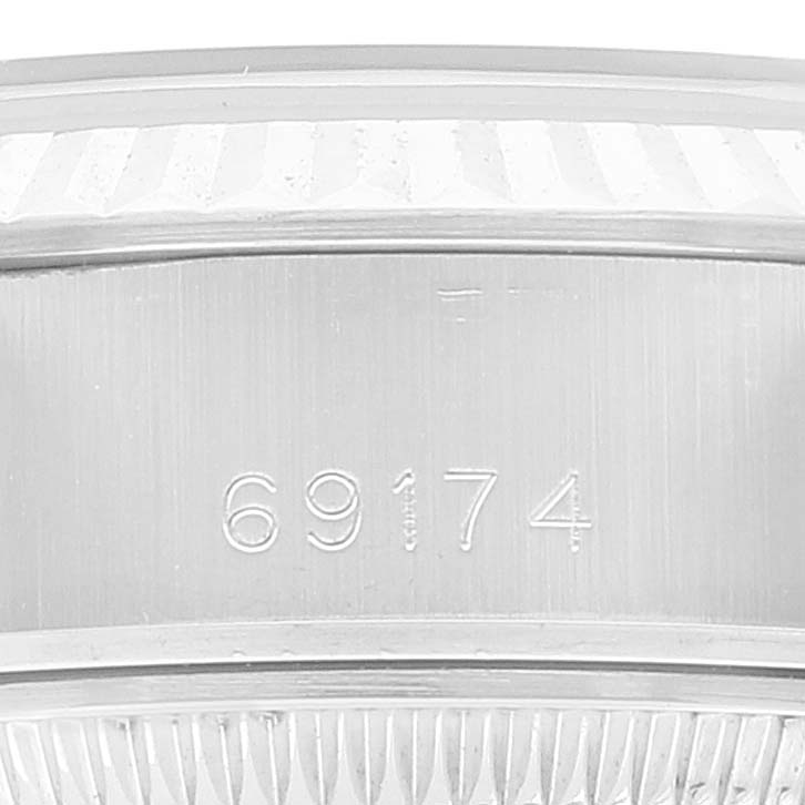 The image shows a close-up of the Rolex Datejust 69174 Women's Stainless Steel Silver Dial 69174 Women's Stainless Steel Silver Dial's model number 69174 engraved on its case.