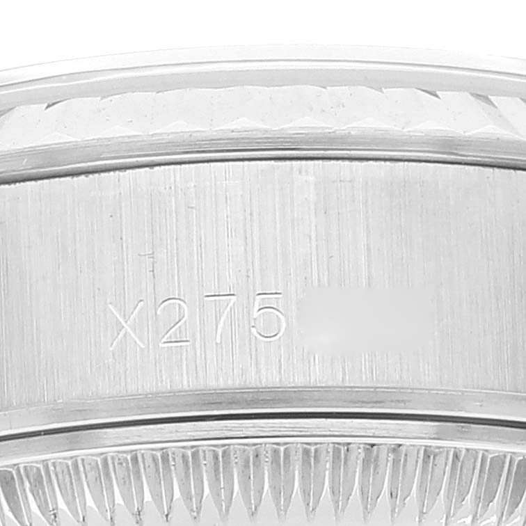 This image shows a close-up angle of the Rolex Datejust 69174 Women's Stainless Steel Silver Dial 69174 Women's Stainless Steel Silver Dial model, highlighting the serial number and fluted bezel.