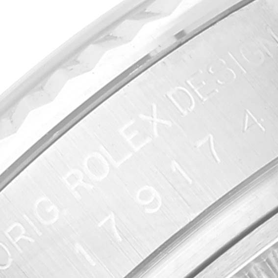 This image shows a close-up of the engravings on the case of a Rolex Datejust 179174 Women's Stainless Steel Pink Dial 179174 Women's Stainless Steel Pink Dial watch.