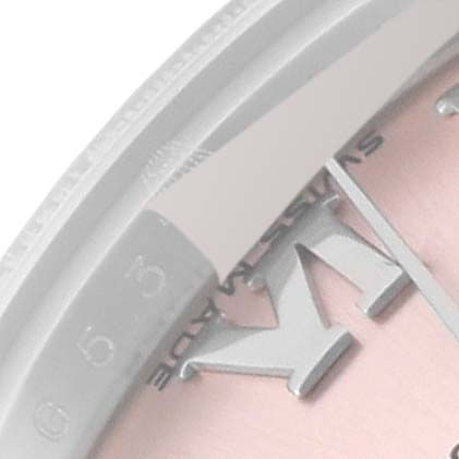 This close-up image shows the Rolex Datejust 179174 Women's Stainless Steel Pink Dial 179174 Women's Stainless Steel Pink Dial watch's bezel, part of the dial, and the "VI" hour marker.