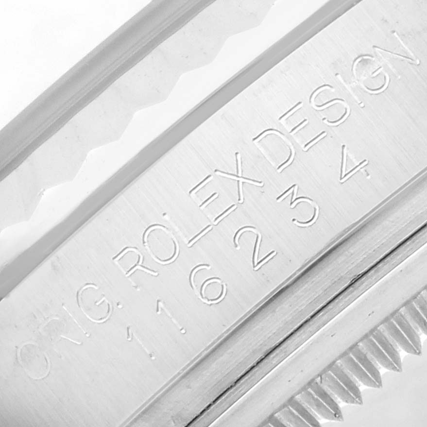 The image shows a close-up of the inner bezel engraving on a Rolex Datejust 116234 Men
s Stainless Steel White Dial watch, displaying the model number and design details.