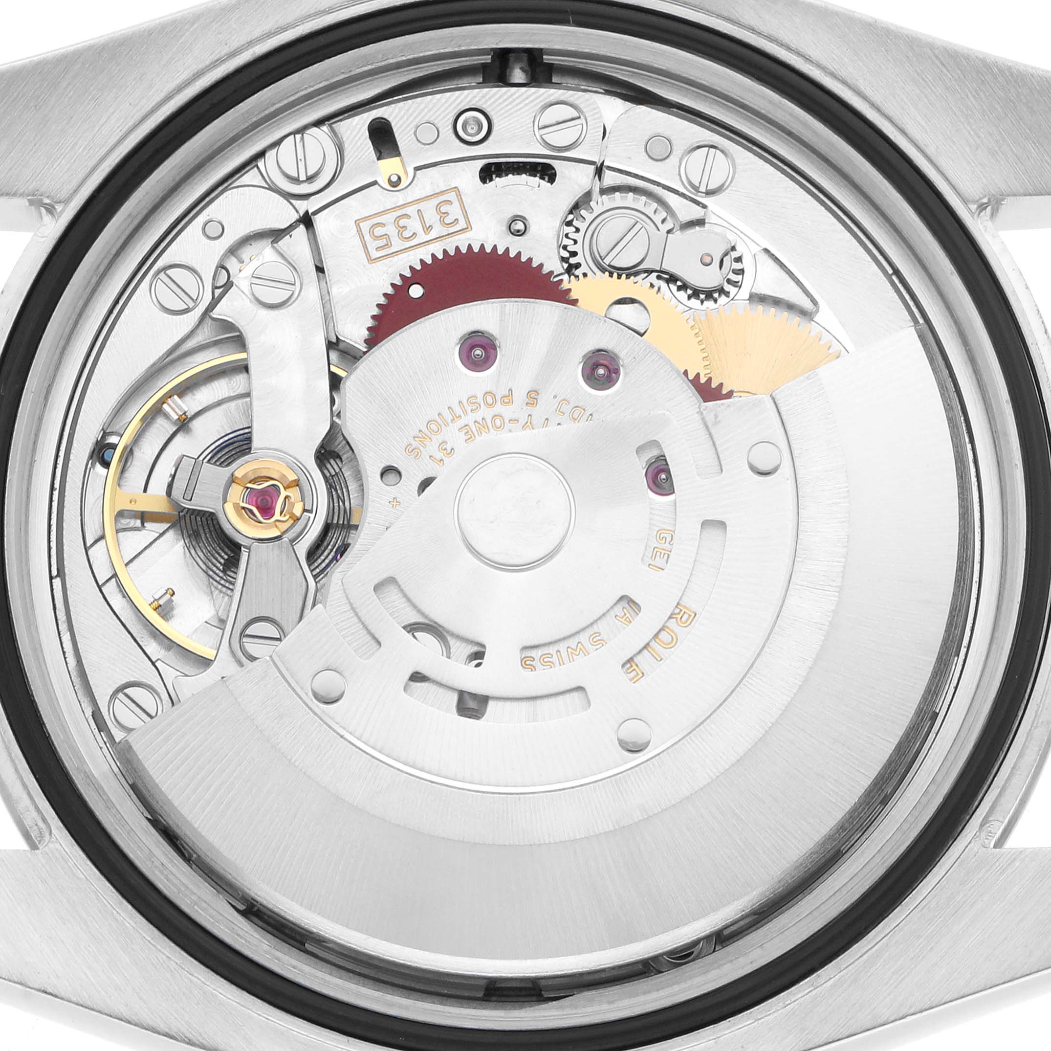The image shows the movement mechanism of a Rolex Datejust 116234 Men
s Stainless Steel White Dial watch from a back angle, highlighting gears and the oscillating weight.