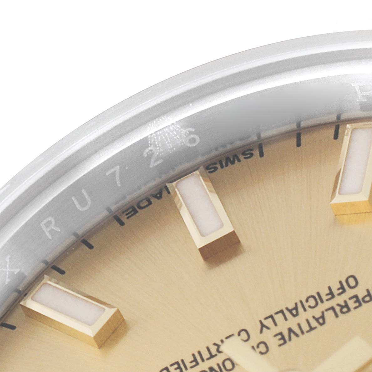 The image shows a close-up of the upper section of the dial and rehaut of a Rolex Datejust 179173 Women's Steel and Gold (two tone) Champagne Dial 179173 Women's Steel and Gold (two tone) Champagne Dial watch, including the logo and some markers.