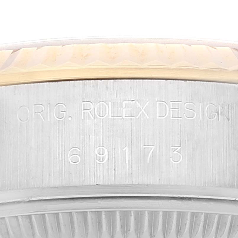This image shows a close-up of the serial number and "ORIG. ROLEX DESIGN" engraving on the case side of a Rolex Datejust 69173 Women's Steel and Gold (two tone) Champagne Dial 69173 Women's Steel and Gold (two tone) Champagne Dial watch.
