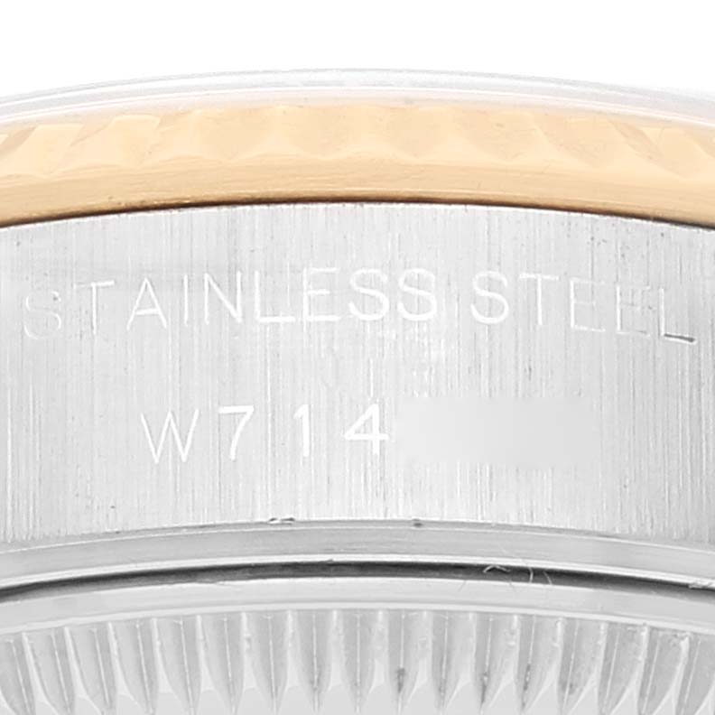 Close-up of the side view of a Rolex Datejust 69173 Women's Steel and Gold (two tone) Champagne Dial 69173 Women's Steel and Gold (two tone) Champagne Dial watch, showing part of the stainless steel case and bezel.