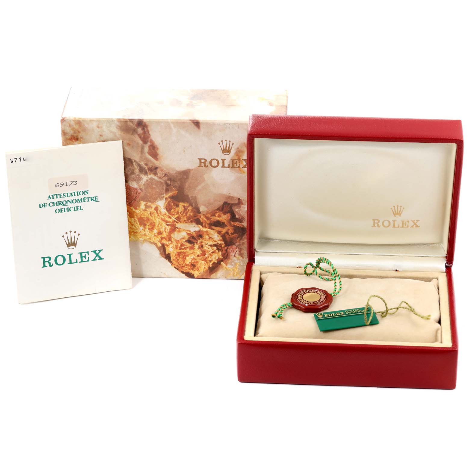 The image shows a red Rolex Datejust 69173 Women's Steel and Gold (two tone) Champagne Dial 69173 Women's Steel and Gold (two tone) Champagne Dial watch box with labels and tags, a booklet, and the outer packaging.