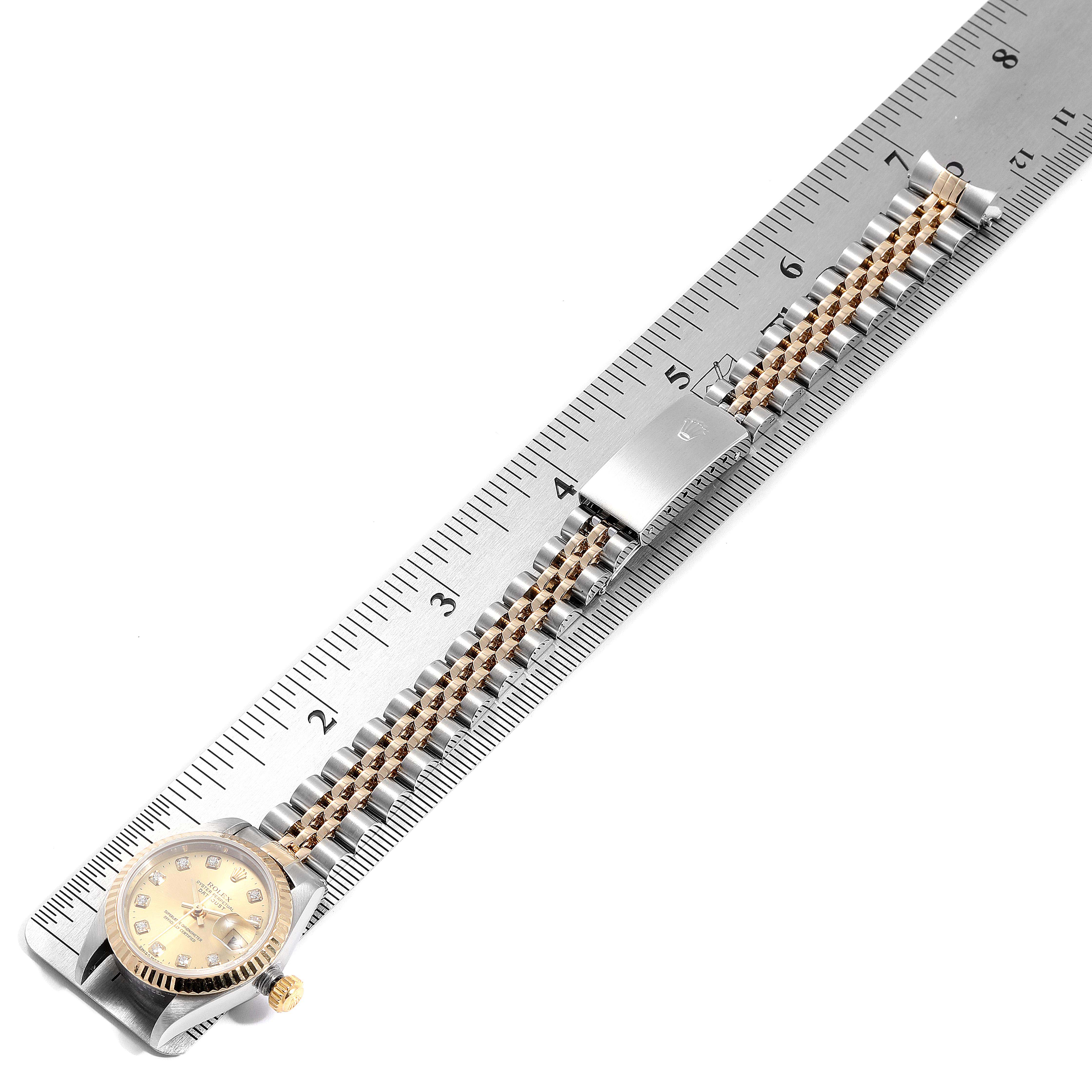 The image shows the Rolex Datejust 79173 Women's Steel and Gold (two tone) Champagne Dial 79173 Women's Steel and Gold (two tone) Champagne Dial watch laid flat with the bracelet and clasp visible, aligned with a ruler for measurement.