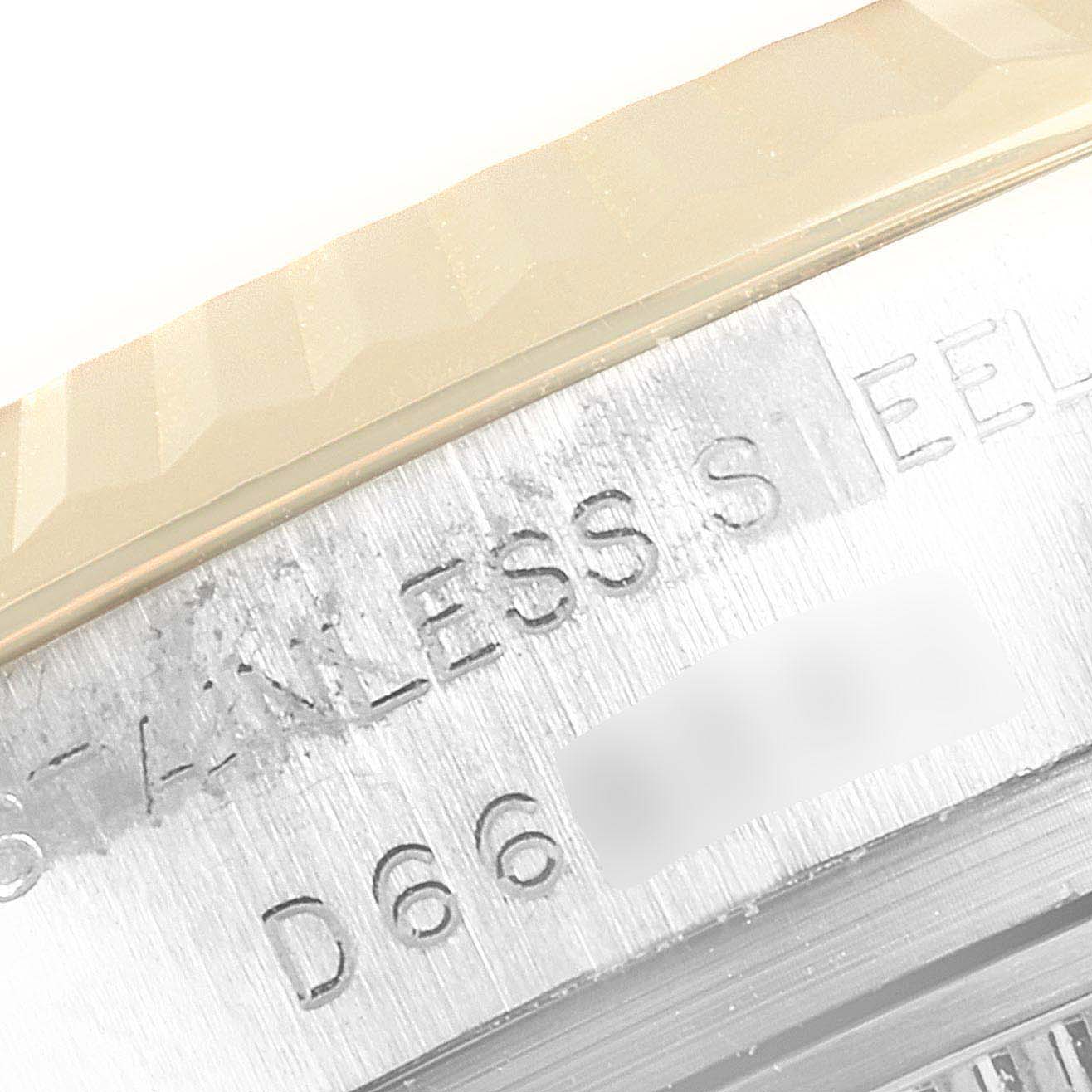 This is a macro shot of the side of a Rolex Datejust 179173 Women's Steel and Gold (two tone) Mother of Pearl Dial 179173 Women's Steel and Gold (two tone) Mother of Pearl Dial watch showing the "STAINLESS STEEL" etching and some serial numbers.