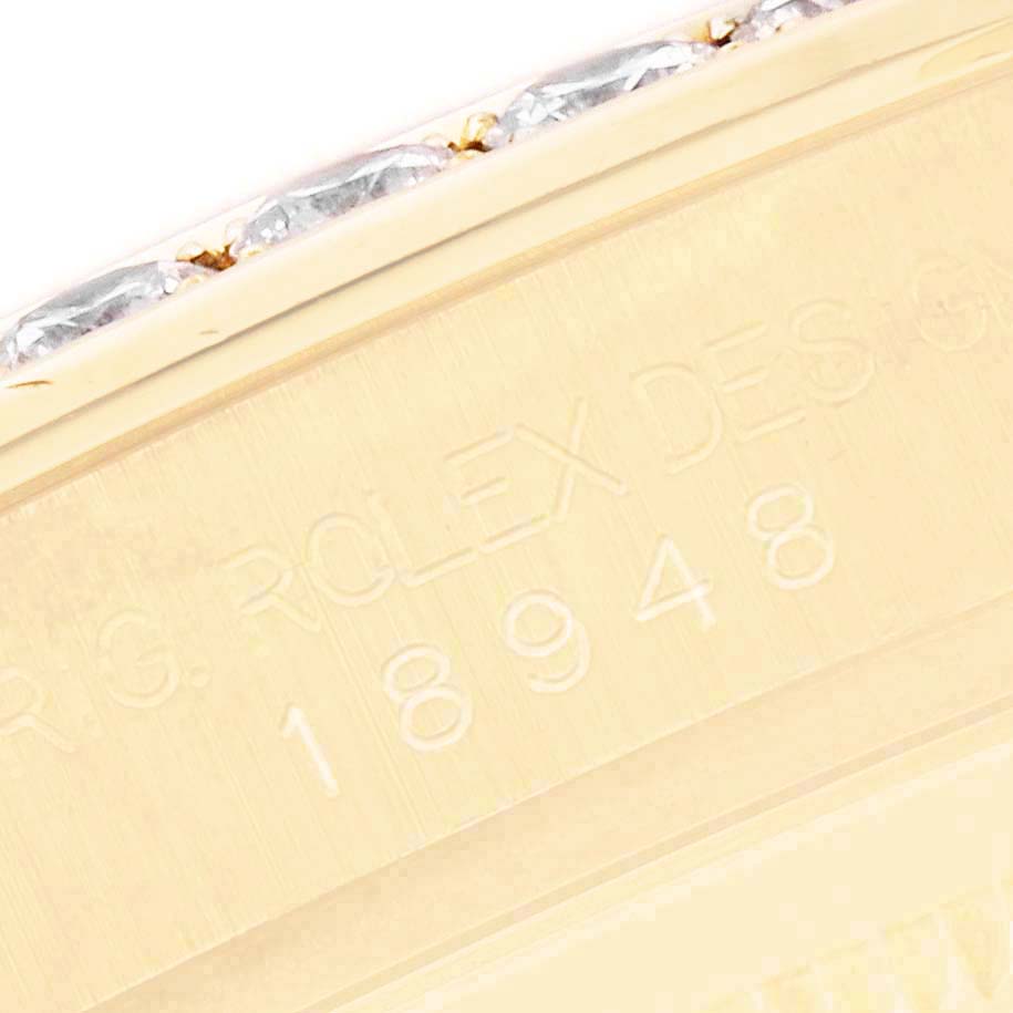 The image shows a close-up of the Rolex Pearlmaster 18948 Men's Yellow Gold Mother of Pearl Dial's engraved case edge.