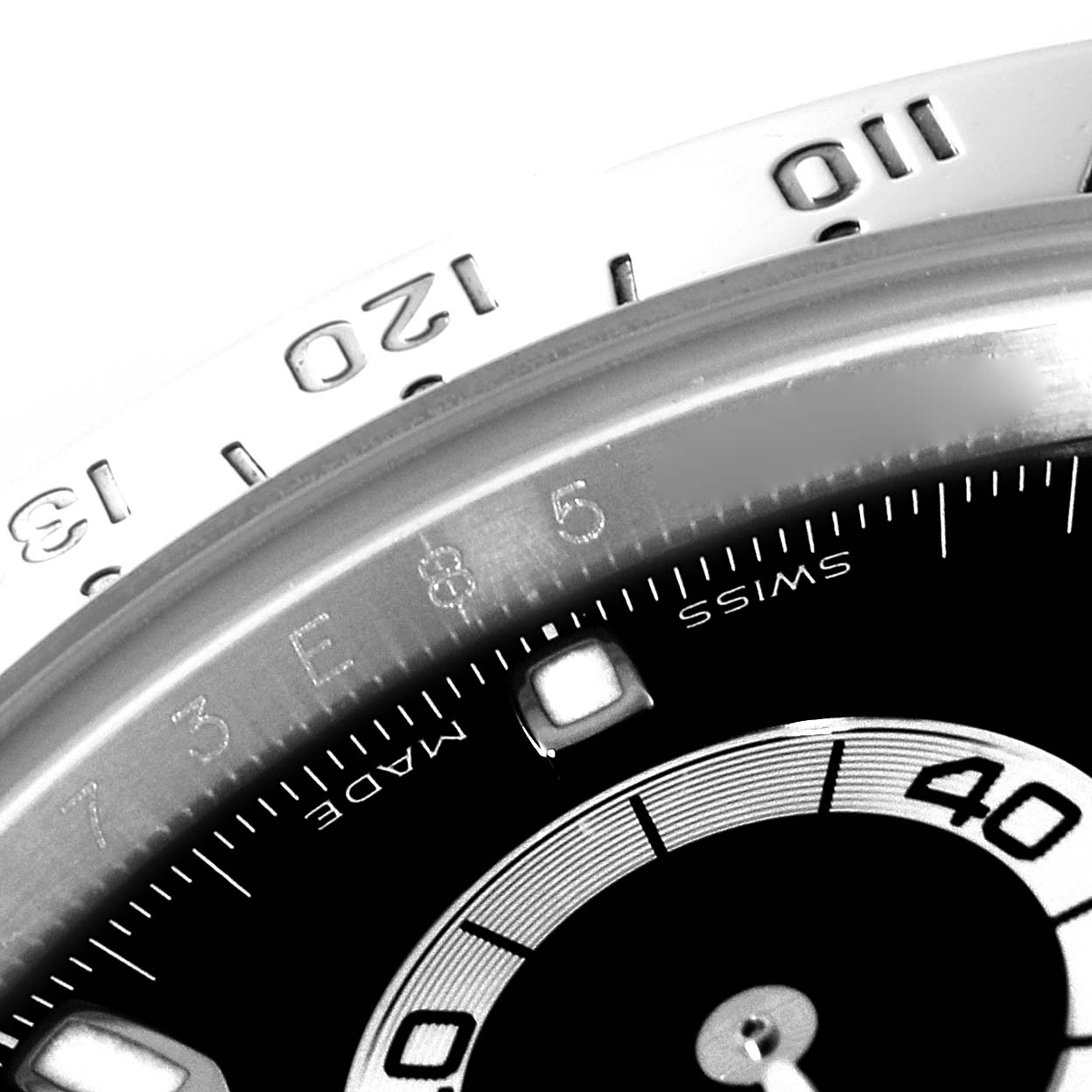 This close-up shows the bezel and part of the dial of the Rolex Daytona 116520 Men
s Stainless Steel Black Dial 116520 Men
s Stainless Steel Black Dial watch.