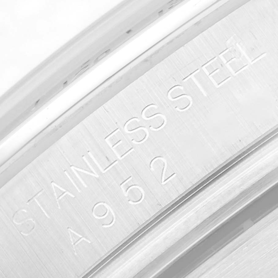 The image shows a close-up of the Rolex Daytona 16520 Men
s Stainless Steel White Dial watch
s inner case back, engraved with "STAINLESS STEEL" and a reference number.