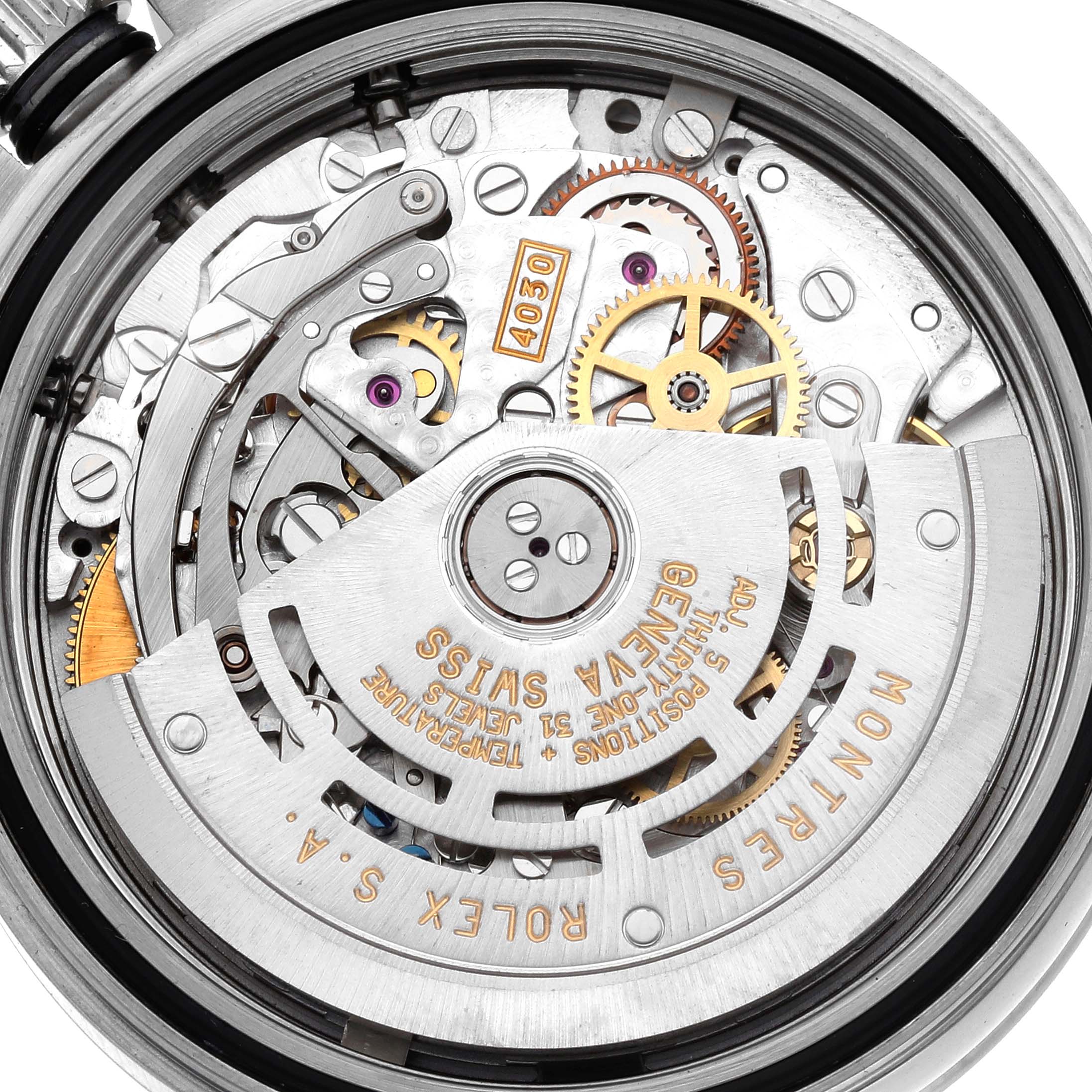 The image shows the back view of a Rolex Daytona 16520 Men
s Stainless Steel White Dial, highlighting the intricate movement and gears inside.