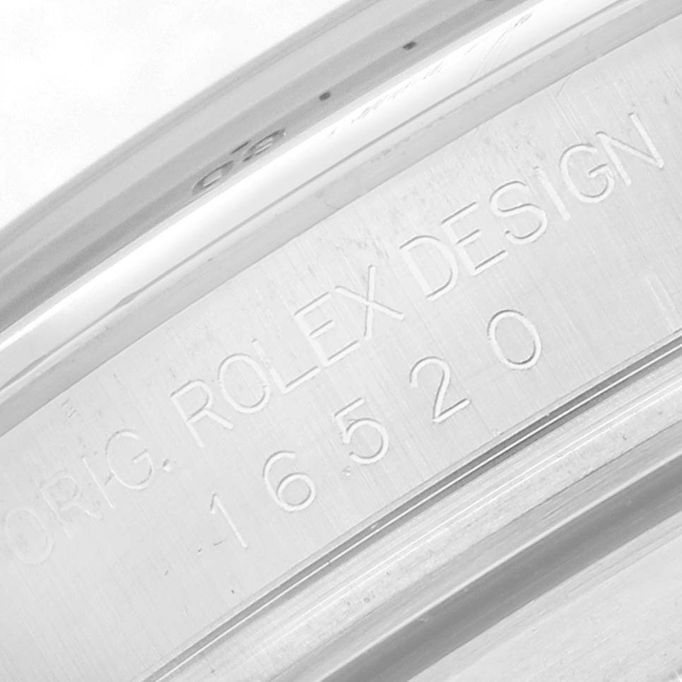 This image shows the engraved inner bezel of a Rolex Daytona 16520 Men
s Stainless Steel White Dial watch at a close-up angle, featuring the model number.