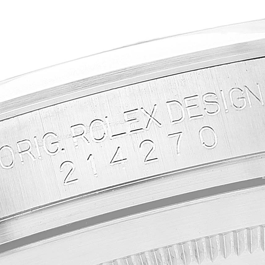 The image shows a close-up of the engraved model number and "ORIG. ROLEX DESIGN" text on the case of a Rolex Explorer 214270 Men's Stainless Steel Black Dial 214270 Men's Stainless Steel Black Dial.