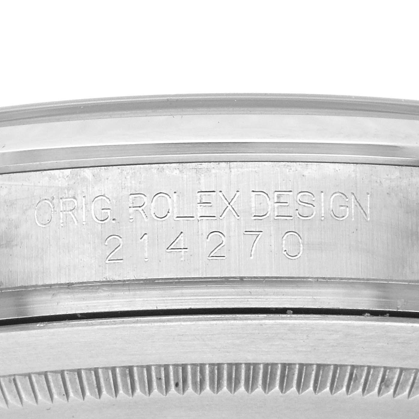 The image shows the side view of a Rolex Explorer 214270 Men's Stainless Steel Black Dial model 214270, focusing on the engraved serial number on the case.