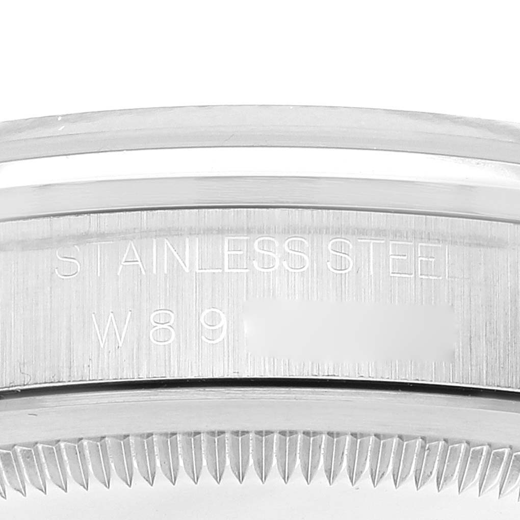 The image shows a close-up of the bezel and case side of a Rolex Explorer 14270 Men
s Stainless Steel Black Dial 14270 Men
s Stainless Steel Black Dial watch, highlighting the "STAINLESS STEEL" engraving.