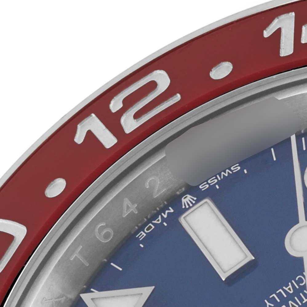 The image shows a close-up of the bezel and part of the dial of a Rolex GMT-Master 126719 Men's White Gold Blue Dial 126719 Men's White Gold Blue Dial watch, highlighting the "12" and "Swiss Made" text.