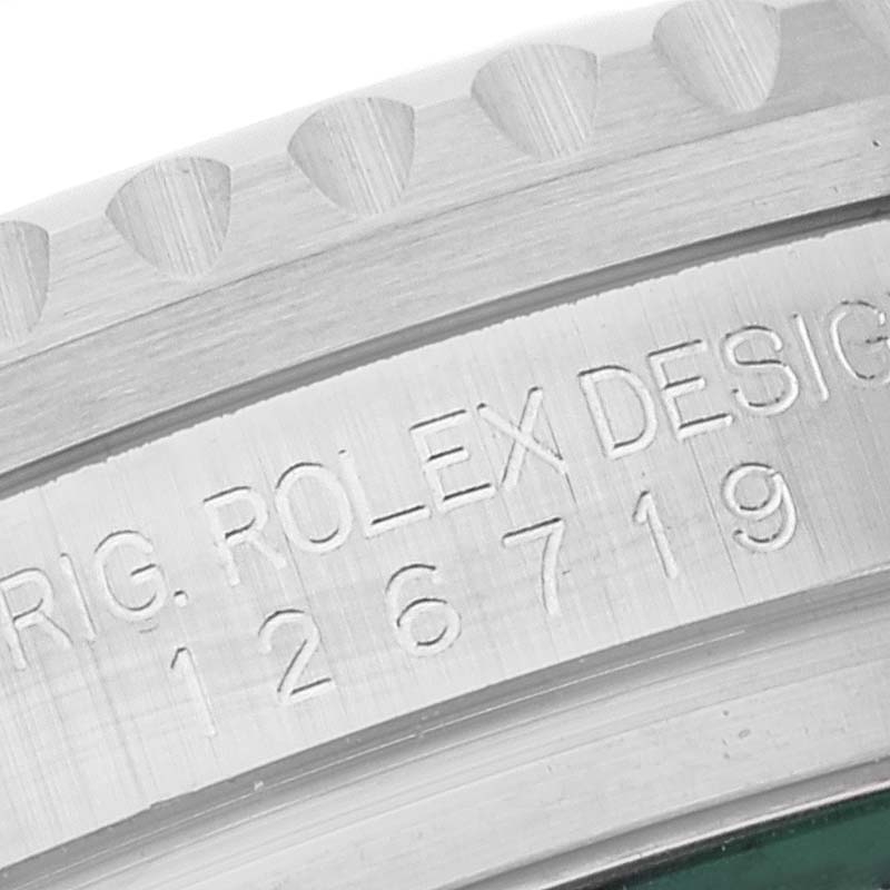The image shows a close-up of the engraved bezel and inscription of the Rolex GMT-Master 126719 Men's White Gold Blue Dial 126719 Men's White Gold Blue Dial watch.