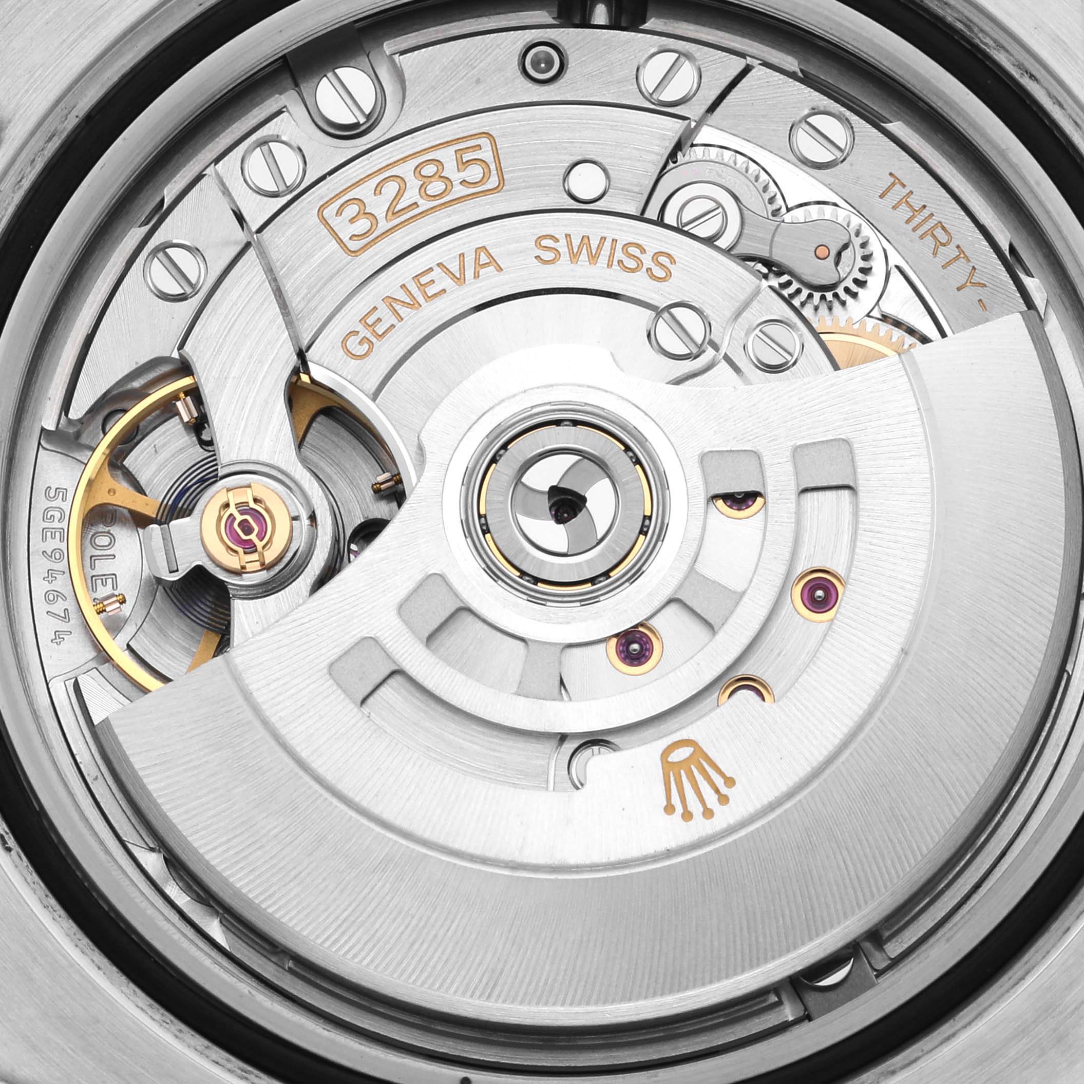 The image shows the movement and inner mechanisms of a Rolex GMT-Master 126710 Men's Stainless Steel Black Dial 126710 Men's Stainless Steel Black Dial, highlighting the rotor and engravings.