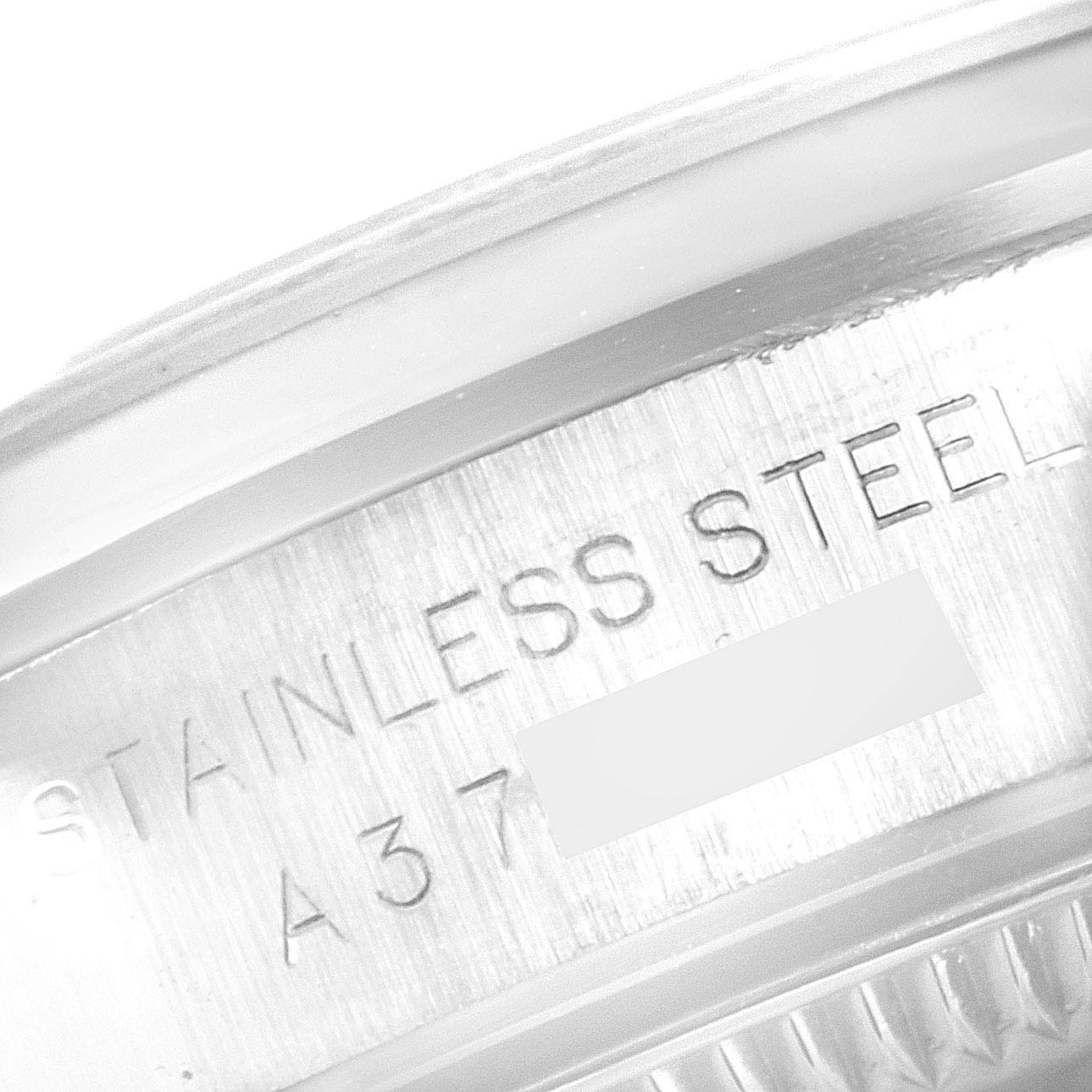 This close-up image of the Rolex Oyster Perpetual 76080 Women's Stainless Steel Black Dial 76080 Women's Stainless Steel Black Dial watch shows the underside of the stainless steel case.