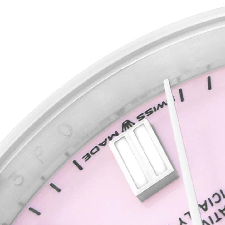 The image shows a close-up of the dial and hour markers of a Rolex Oyster Perpetual 126000 Men
s Stainless Steel Pink Dial watch, viewed from an angle highlighting the "Swiss Made" text.
