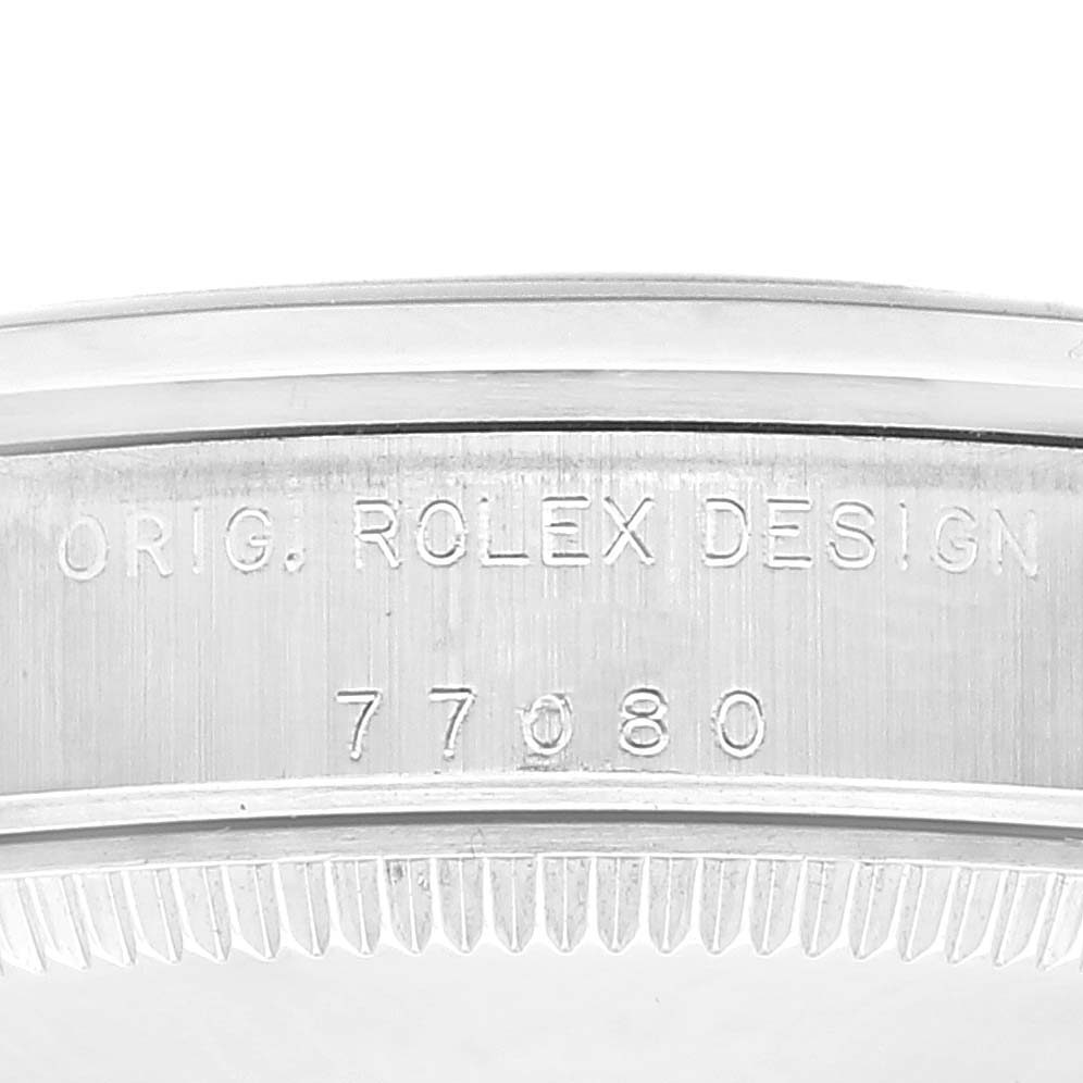 This image displays a close-up of the case engraving on a Rolex Mid-Size 77080 Women's Stainless Steel Pink Dial 77080 Women's Stainless Steel Pink Dial model, showing the "ORIG. ROLEX DESIGN" and model number "77080."