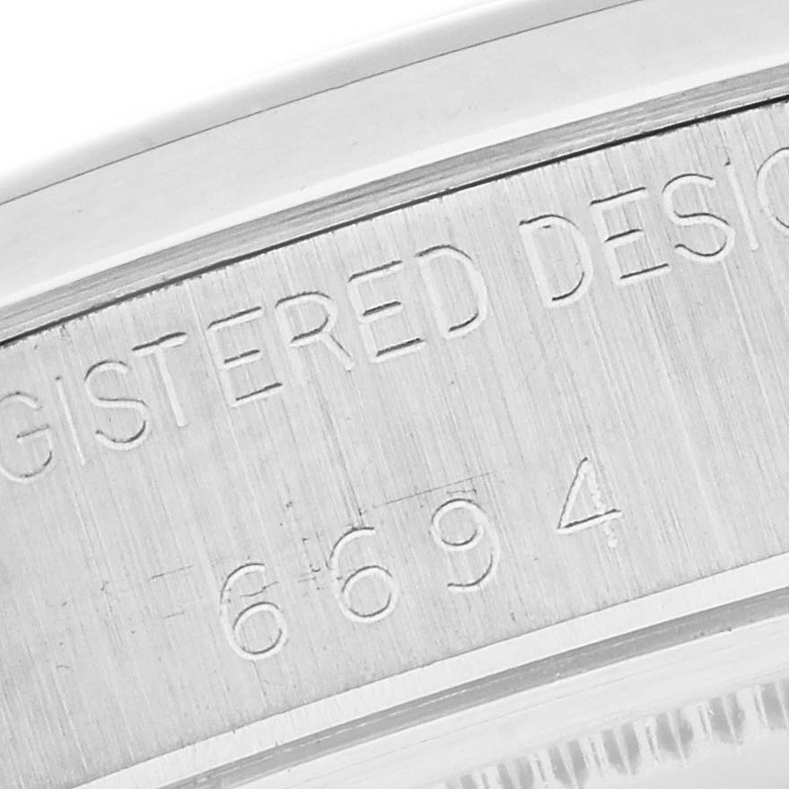 This close-up shot of the Rolex Vintage Collection 6694 Men
s Stainless Steel Champagne Dial 6694 Men
s Stainless Steel Champagne Dial model shows the engraved serial number on the watch case back.