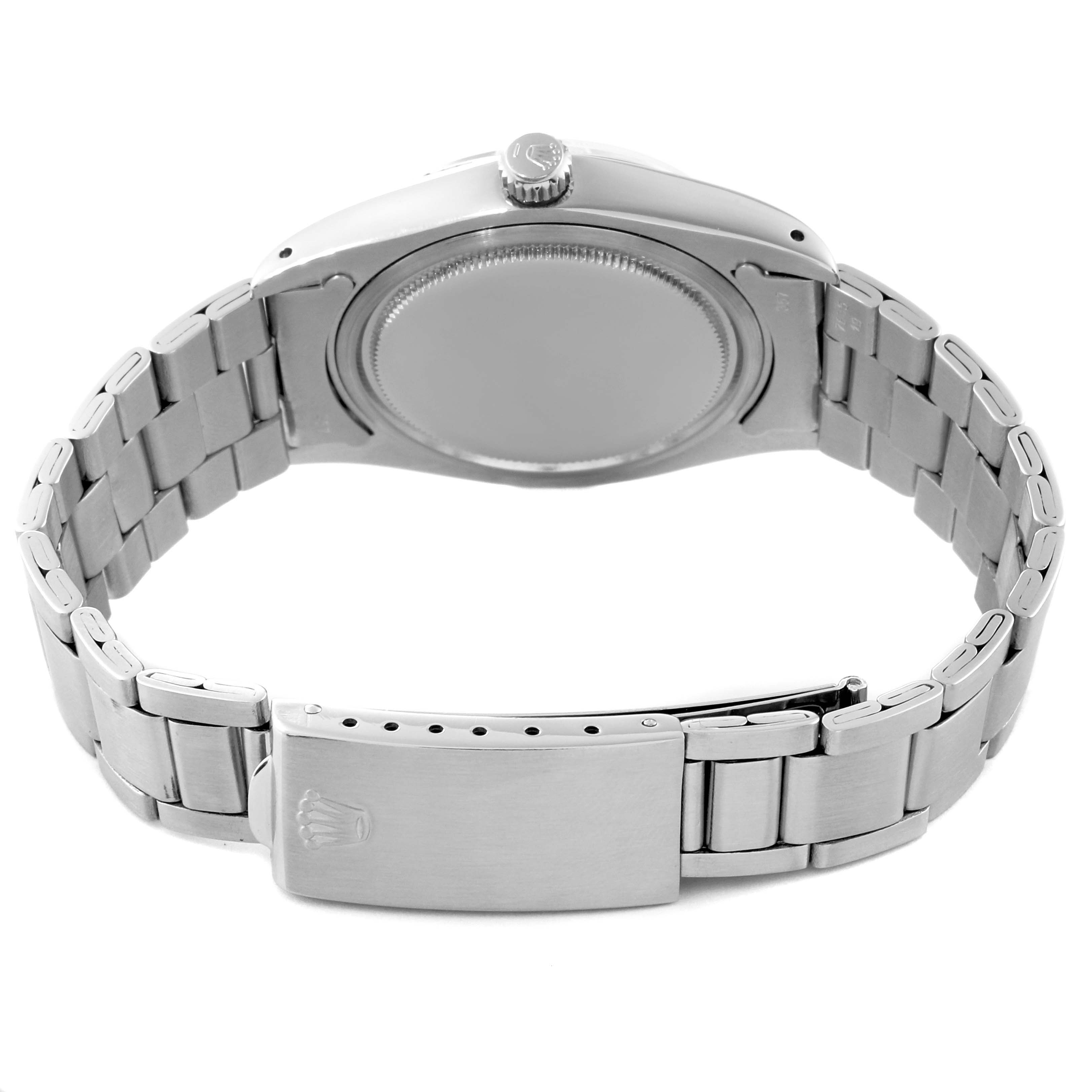 This image shows the back view of the Rolex Vintage Collection 6694 Men
s Stainless Steel Champagne Dial 6694 Men
s Stainless Steel Champagne Dial model, highlighting the case back, crown, and metal bracelet with the clasp.