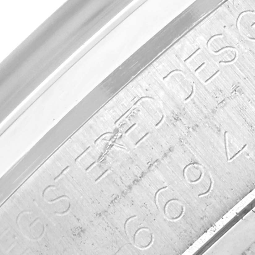 The close-up angle shows the engraved bezel and part of the casing for the Rolex Vintage Collection 6694 Men's Stainless Steel Silver Dial 6694 Men's Stainless Steel Silver Dial watch.