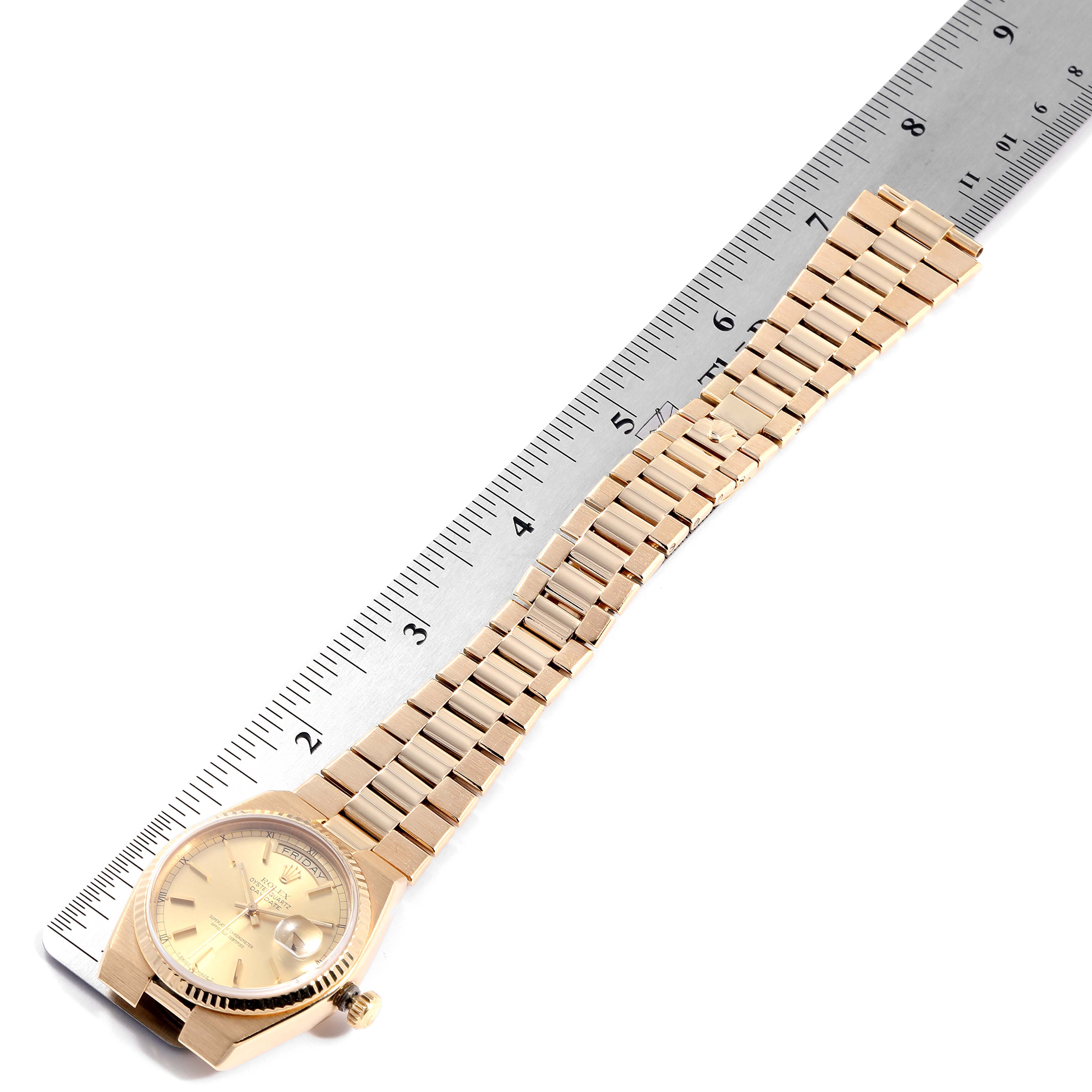 The Rolex Oysterquartz 25260 Men
s Yellow Gold Champagne Dial 25260 Men
s Yellow Gold Champagne Dial watch is shown at an angle displaying the full bracelet and face, with a ruler for scale.