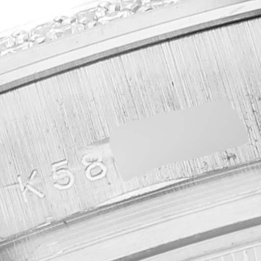 The image shows a close-up of the engraved serial number on the bezel of a Rolex Pearlmaster 80339 Women
s White Gold Mother of Pearl Dial 80339 Women
s White Gold Mother of Pearl Dial watch.