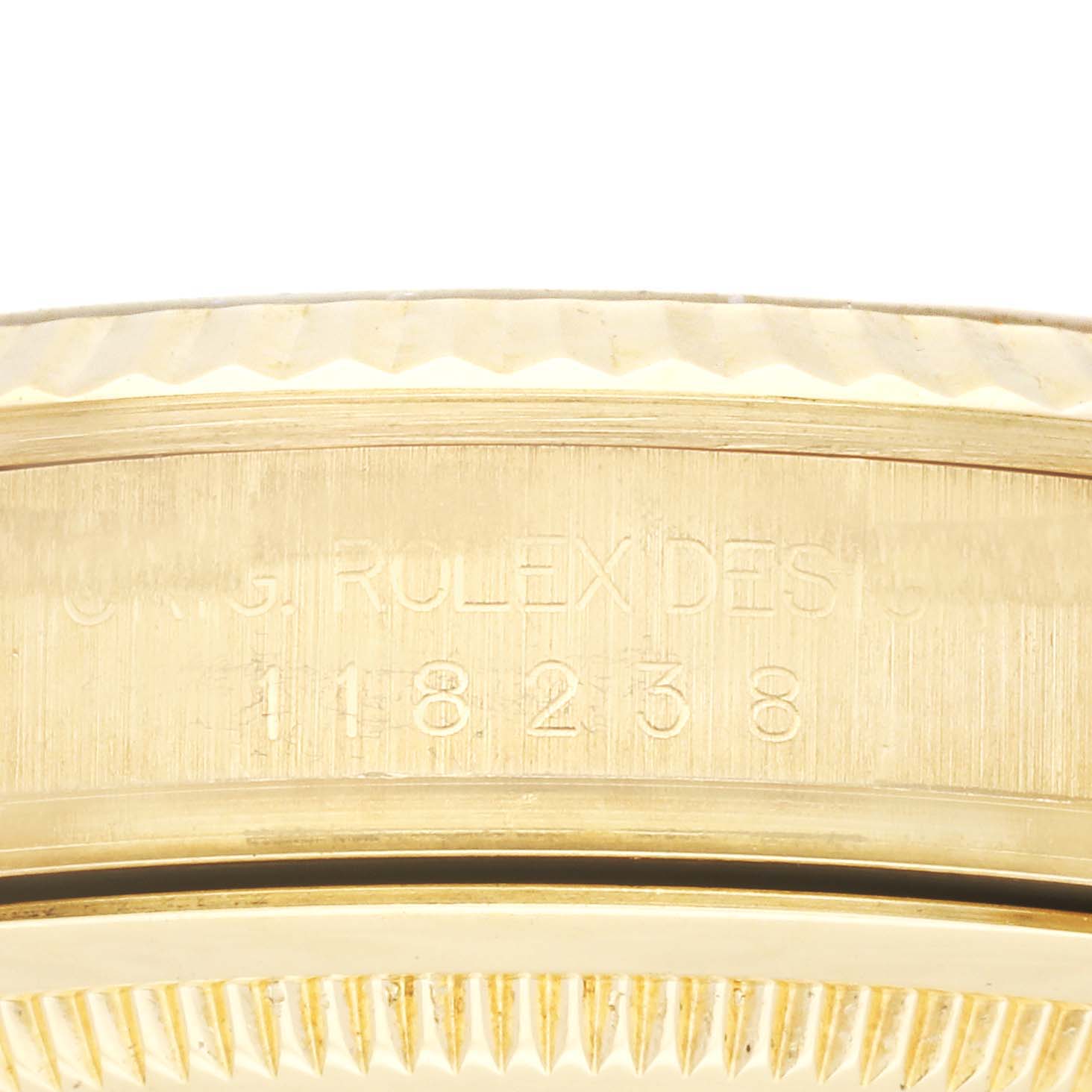 This close-up image shows the engraved bezel area of a Rolex President 118238 Men
s Yellow Gold Champagne Dial 118238 Men
s Yellow Gold Champagne Dial model watch.