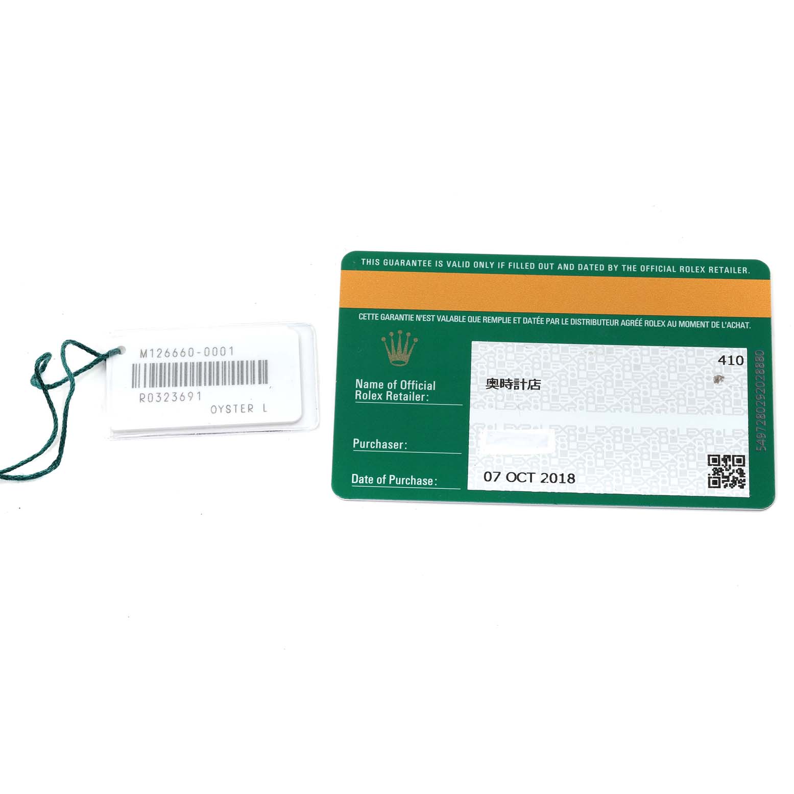 This image shows the warranty card and a tag for the Rolex Sea-Dweller 126660 Men
s Stainless Steel Black Dial 126660 Men
s Stainless Steel Black Dial model.