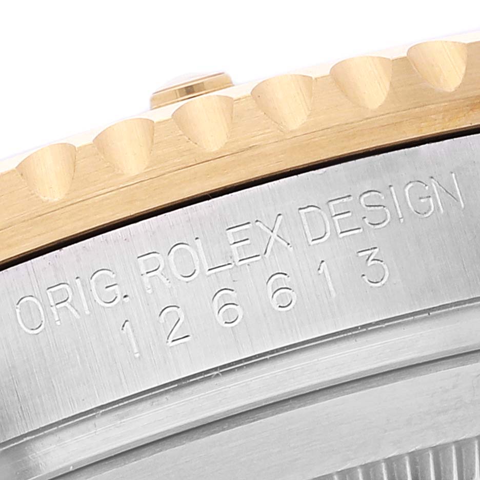 This image shows an angled close-up of the model number and design engraving on the outer edge of the Rolex Submariner 126613 Men
s Steel and Gold (two tone) Blue Dial 126613 Men
s Steel and Gold (two tone) Blue Dial watch case.