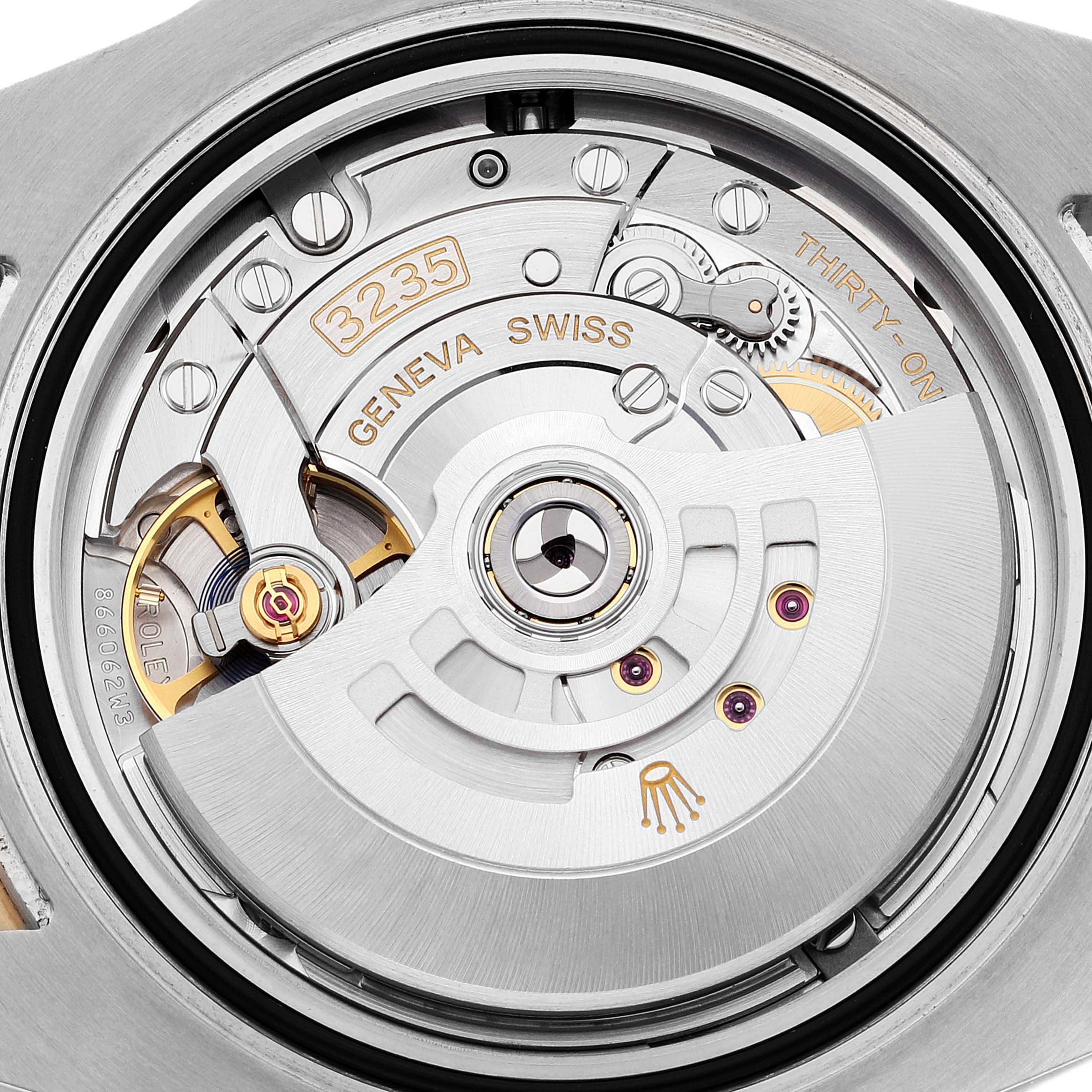 The image shows a close-up of the Rolex Submariner 126613 Men
s Steel and Gold (two tone) Blue Dial 126613 Men
s Steel and Gold (two tone) Blue Dial
s movement, highlighting the intricate mechanical parts and engravings.