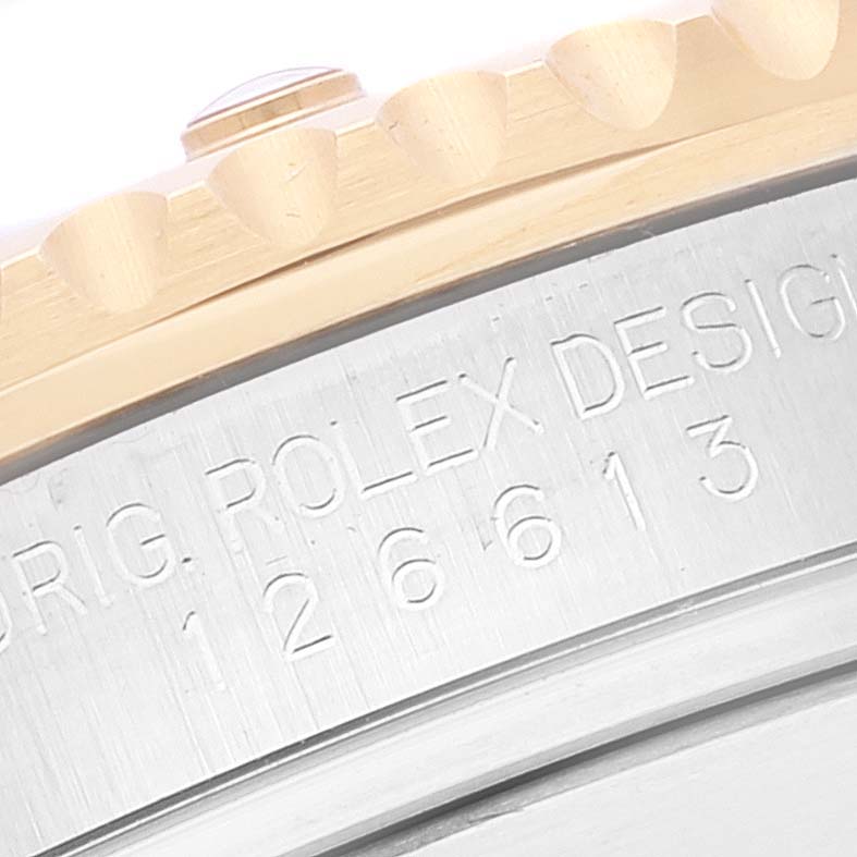 The image shows a close-up of the bezel and engraved case side of a Rolex Submariner 126613 Men's Steel and Gold (two tone) Blue Dial 126613 Men's Steel and Gold (two tone) Blue Dial watch, highlighting the model number and "ROLEX DESIGN" inscription.