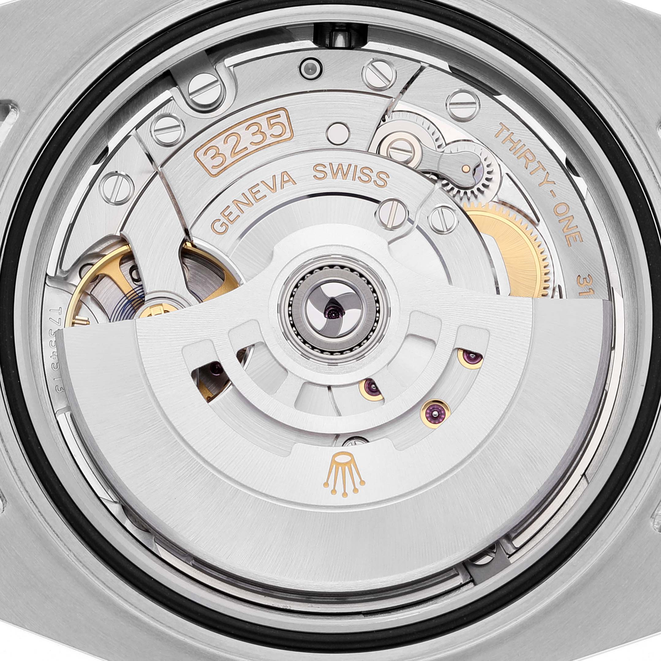 This image shows the movement and interior mechanics of the Rolex Submariner 126613 Men's Steel and Gold (two tone) Blue Dial 126613 Men's Steel and Gold (two tone) Blue Dial watch at close-up angle, featuring the rotor and engravings.