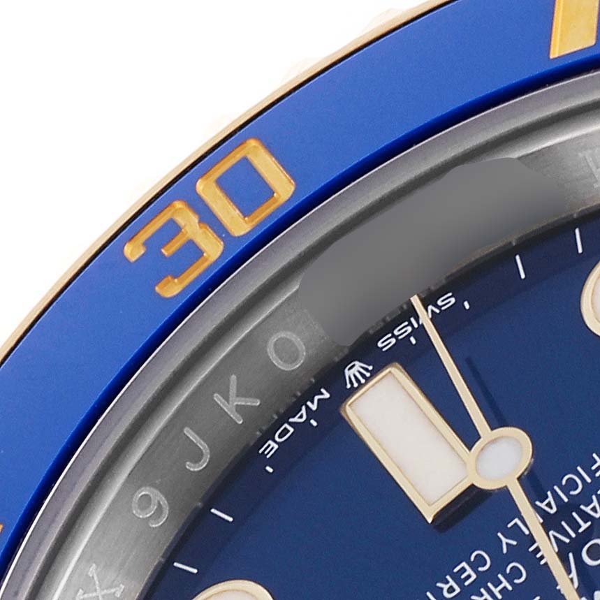 This image shows a close-up view of the Rolex Submariner 126613 Men's Steel and Gold (two tone) Blue Dial 126613 Men's Steel and Gold (two tone) Blue Dial's bezel and dial, highlighting the 30-minute marker on the bezel.