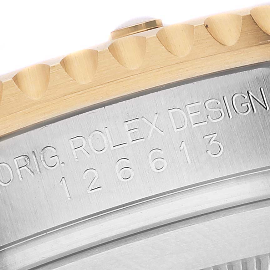 This image shows a close-up angle of the Rolex Submariner 126613 Men's Steel and Gold (two tone) Blue Dial 126613 Men's Steel and Gold (two tone) Blue Dial model, specifically the bezel and case side with engraved text.