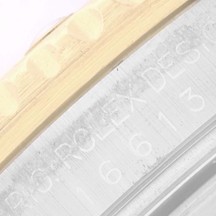 This close-up image shows the engraved details on the side of the bezel and case of a Rolex Submariner 16613 Men's Steel and Gold (two tone) Blue Dial 16613 Men's Steel and Gold (two tone) Blue Dial watch.