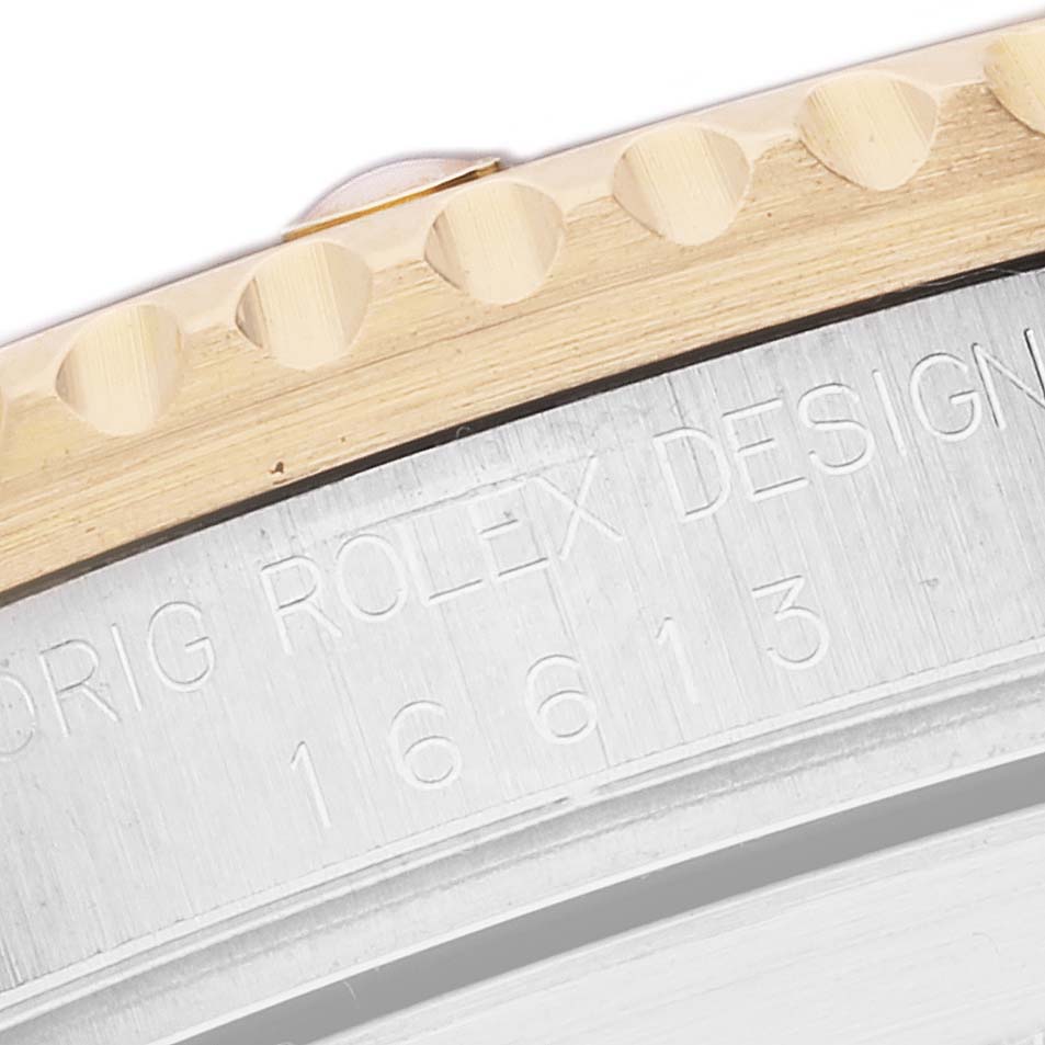 This image shows a close-up of the Rolex Submariner 16613 Men's Steel and Gold (two tone) Blue Dial 16613 Men's Steel and Gold (two tone) Blue Dial 16613 model's case edge and part of the bezel.