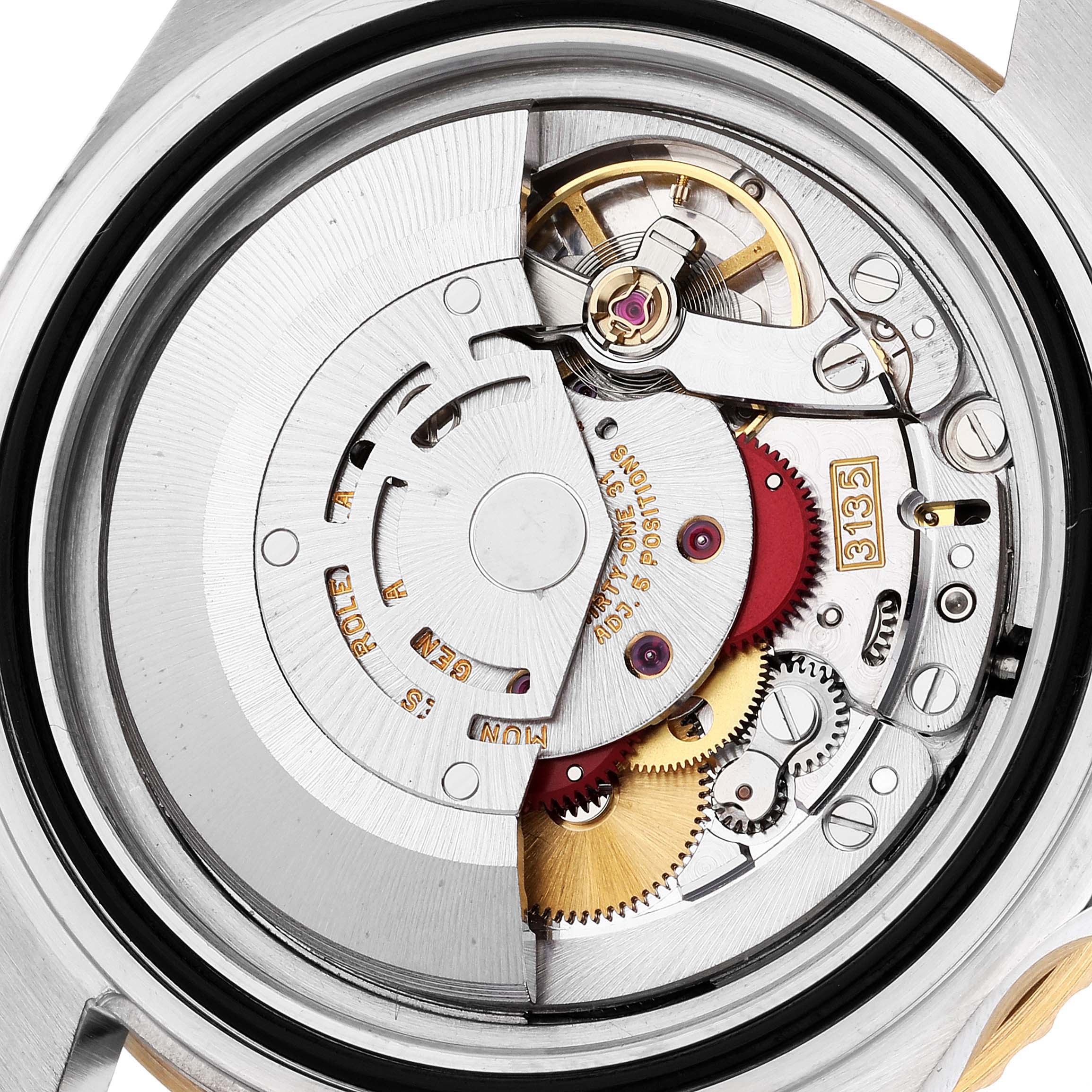 The image shows the intricate internal mechanism of a Rolex Submariner 16613 Men's Steel and Gold (two tone) Blue Dial 16613 Men's Steel and Gold (two tone) Blue Dial watch viewed from the back.