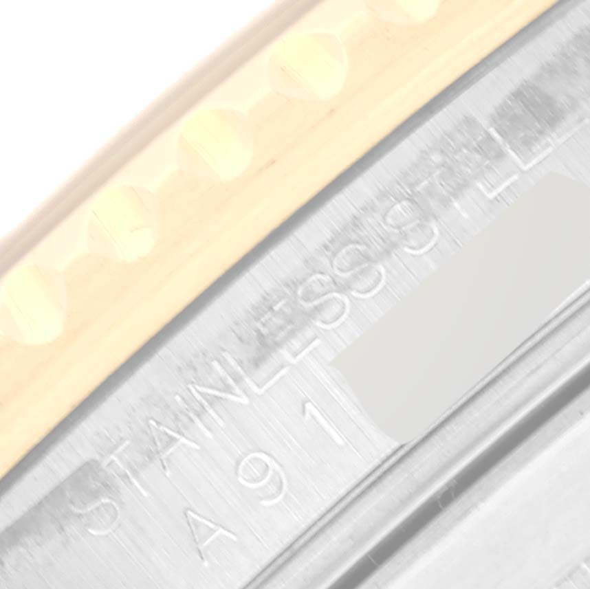 This close-up image shows the side of the bezel and the edge of the case of a Rolex Submariner 16613 Men's Steel and Gold (two tone) Black Dial 16613 Men's Steel and Gold (two tone) Black Dial, revealing the stainless steel material.