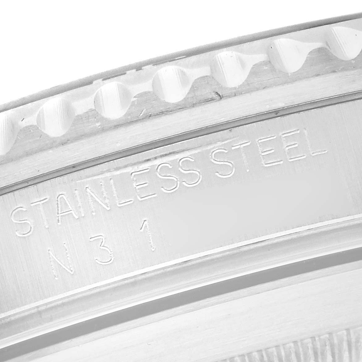 The image shows a close-up of the stainless steel bezel and markings on the Rolex Submariner 16610 Men
s Stainless Steel Black Dial.