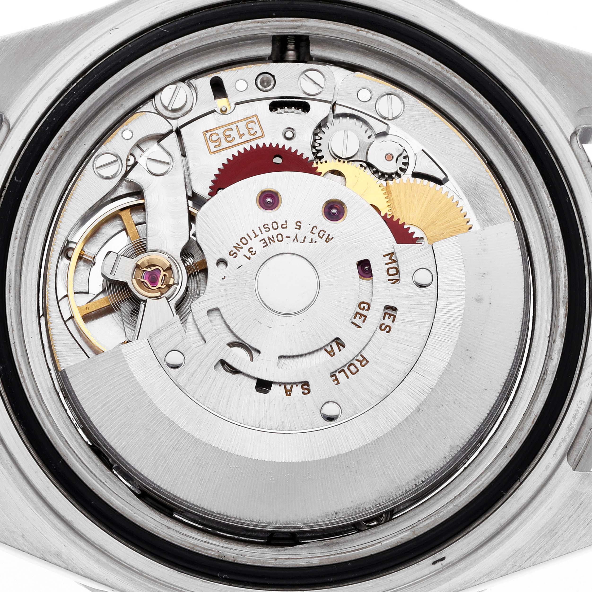 The image shows the movement from the back angle of a Rolex Submariner 16610 Men
s Stainless Steel Black Dial, highlighting its intricate mechanical components.