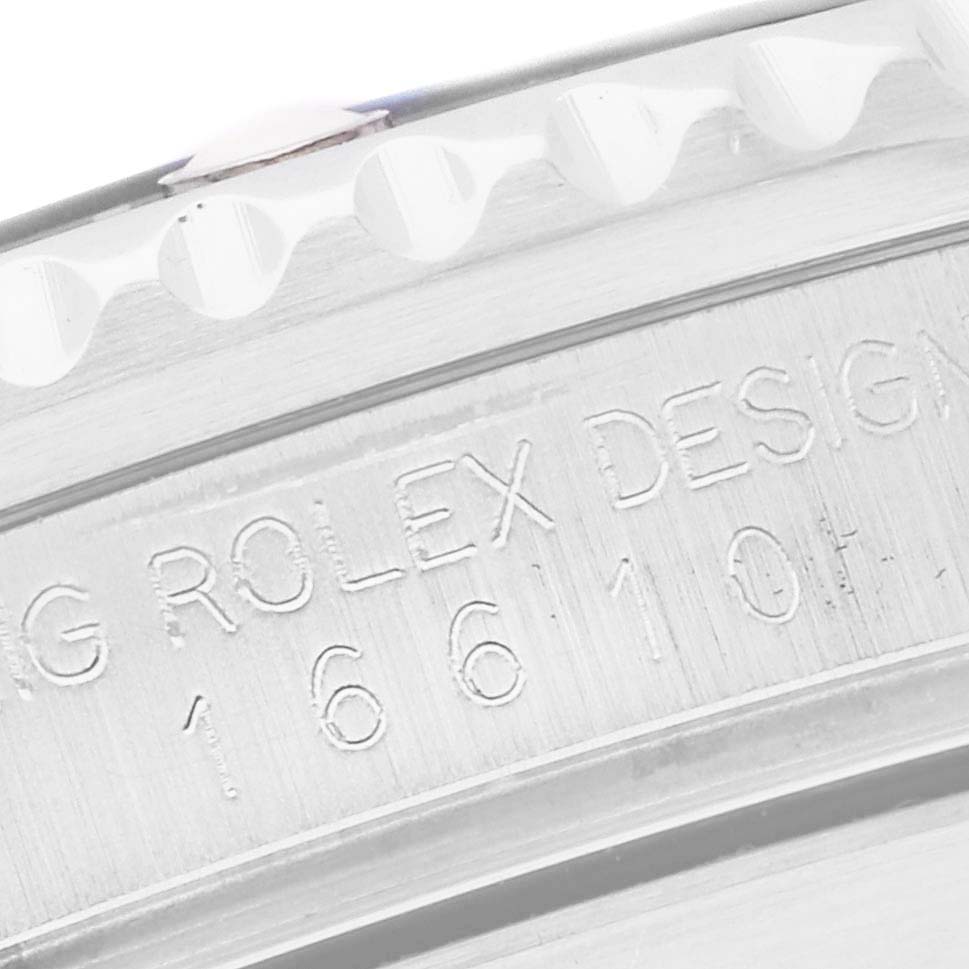 The image shows a close-up of the engraved edge and bezel of a Rolex Submariner 16610 Men
s Stainless Steel Black Dial watch.