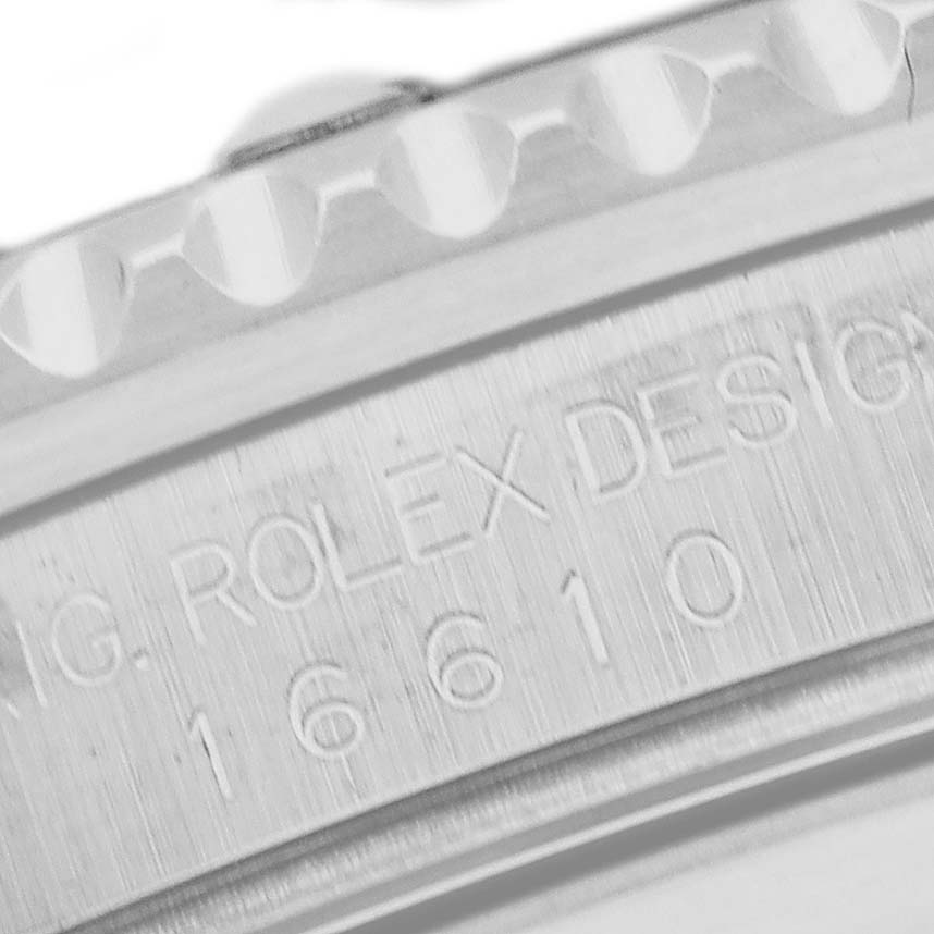The image shows a close-up of the Rolex Submariner 16610 Men
s Stainless Steel Black Dial
s case, focusing on the engraved model and serial number.