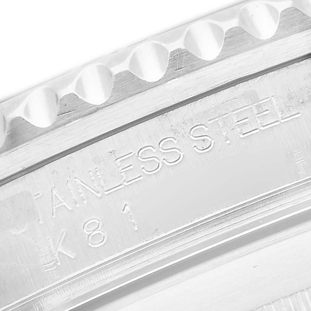 This image shows a close-up of the side bezel and engraved text on a Rolex Submariner 16610 Men
s Stainless Steel Black Dial
s stainless steel case.