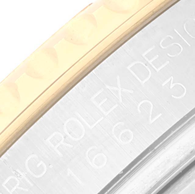 This is a close-up of the bezel and case of a Rolex Yacht-Master 16623 Men's Steel and Gold (two tone) Blue Dial 16623 Men's Steel and Gold (two tone) Blue Dial, showing engraved details.
