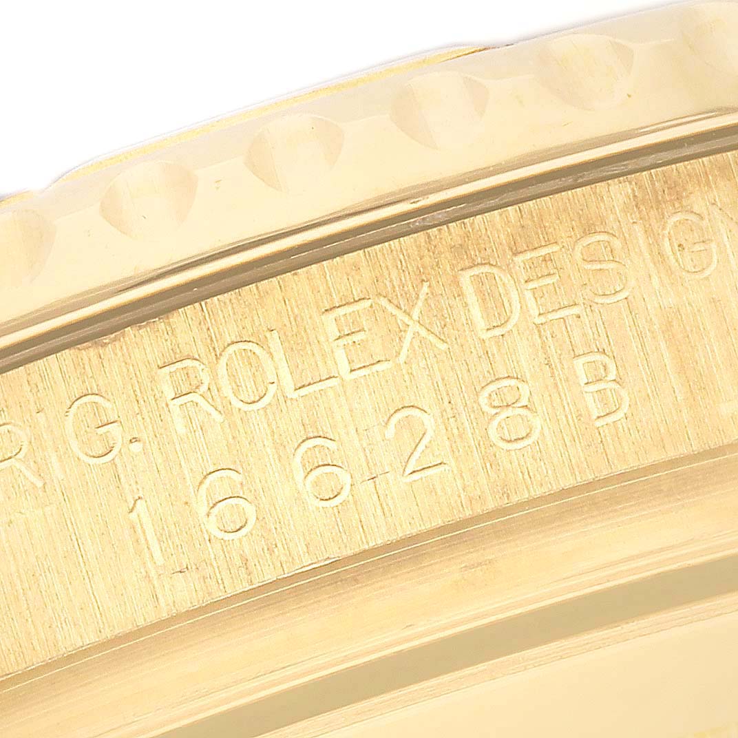 This close-up image shows the engraved text on the side of the bezel of a Rolex Yacht-Master 16628 Men's Yellow Gold White Dial 16628 Men's Yellow Gold White Dial watch.